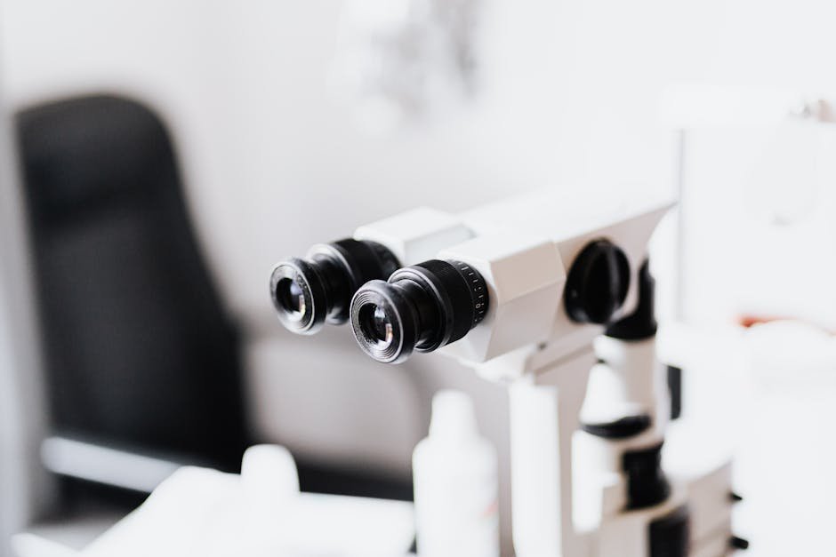 Close-up of a professional microscope in a laboratory environment with selective focus.
